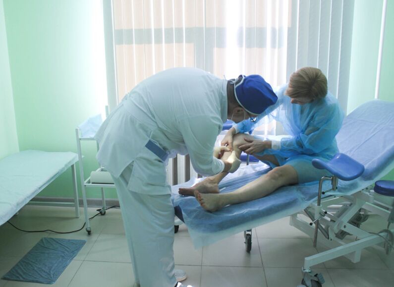 The surgeon examines the patient's veins before performing surgery.